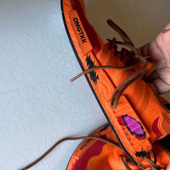 Adidas The South Park x  NMD_R1 \'Kenny\' sneakers feature a vibrant orange knit u
